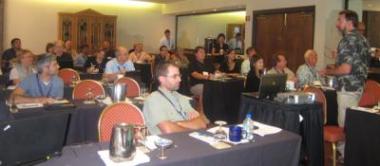 Conference attendees listening to a workshop presenter