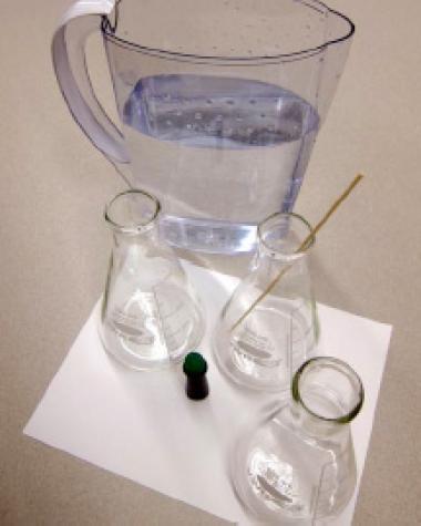 Photo of a jug of water and three Erlenmeyer flasks